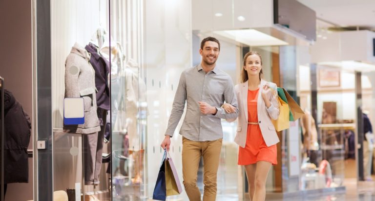 Un couple faisant du shopping et qui utilise le chèque cadeau.